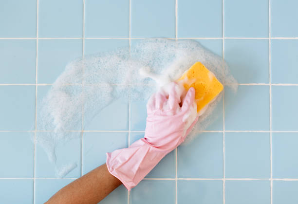 Hand in pink glove with sponge washing